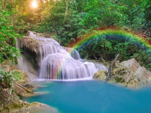 Wonderful Waterfall with rainbows in deep forest at national par